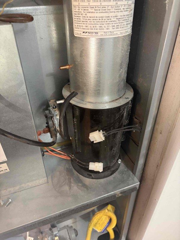 Returned to the site to replace the combustion (draft inducer) motor on the furnace, which showed soot discoloration and heat damage at the housing. Removed the failed inducer assembly, installed the new motor with the flue collar and wiring connections secured, then verified proper voltage at the motor with a multimeter and confirmed correct operation.