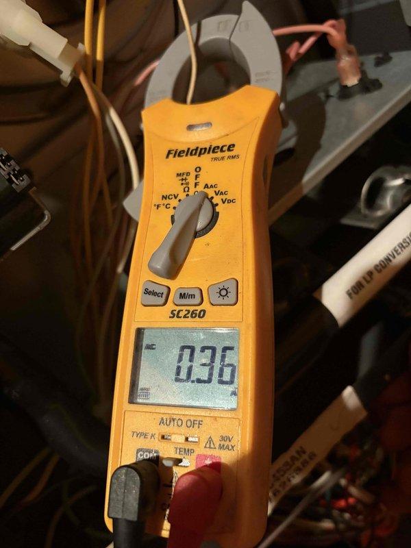 Responded to complaint of furnace failing to reach the 65°F setpoint on an approximately 11-year-old unit. Inspected the inducer motor and pressure switch circuit, verifying draft pressure with a digital manometer and measuring amp draw on the control wiring with a clamp meter. Confirmed the unit is equipped with an LP conversion kit and tested the system for proper operation; the furnace is now heating and cycling normally.