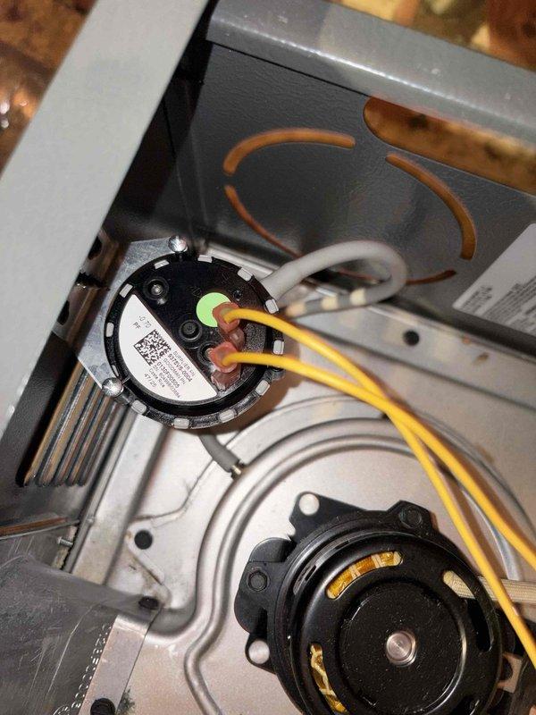 Returned to the job site to install a new pressure switch on the Goodman gas furnace, which is located in the attic. Removed the faulty switch, mounted the replacement on the bracket, and reconnected the wiring to the proper terminals. Verified secure connections and inspected the inducer motor and surrounding components, finding no visible damage, corrosion, or wiring issues.