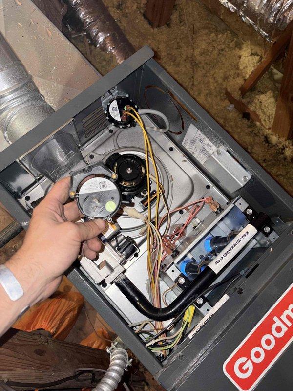 Returned to the job site to install a new pressure switch on the Goodman gas furnace, which is located in the attic. Removed the faulty switch, mounted the replacement on the bracket, and reconnected the wiring to the proper terminals. Verified secure connections and inspected the inducer motor and surrounding components, finding no visible damage, corrosion, or wiring issues.