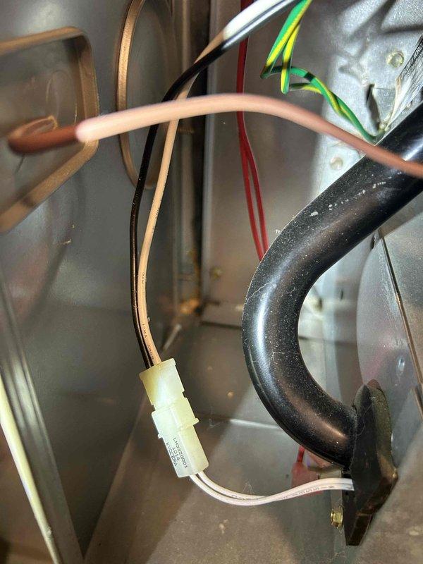 Performed a tune-up on the furnace in response to a reported rattling noise during operation, inspecting the cabinet interior, wiring connections, and vent/flue tubing for loose or worn components. Conducted a combustion analysis with a Testo 310 analyzer, which recorded 7.4% O2 and 100 ppm CO, indicating CO levels at the upper limit of acceptable range and warranting further burner and heat exchanger evaluation. Interior of the cabinet showed dust accumulation and minor surface corrosion near the seam, which should be monitored.