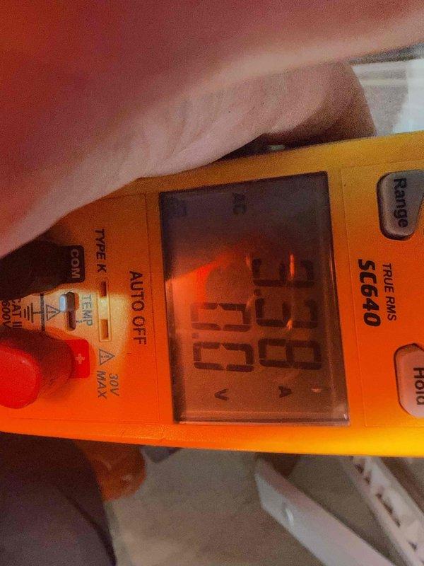 Performed scheduled preventive maintenance on the HVAC system and whole-house humidifier under the prepaid maintenance plan. Inspected the humidifier and found heavy mineral scale buildup on the evaporator pad, indicating the pad is due for cleaning or replacement. Verified electrical operation with a true-RMS clamp meter, measuring AC voltage at the unit to confirm proper supply.