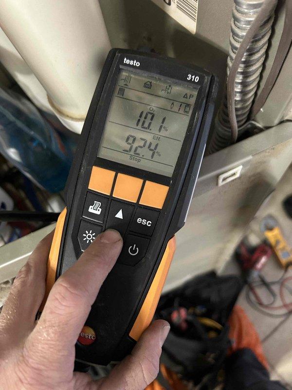Responded to a no-heat complaint on the upstairs air handler unit blowing lukewarm air. Performed a combustion analysis (10.1% CO2, 92.4% efficiency) and verified gas manifold pressure with a digital manometer (3.37 in. w.c.) at the gas valve, confirming the furnace was firing within manufacturer specifications. Noted dusty, corroded gas piping and furnace interior conditions; system is operating and producing heat.