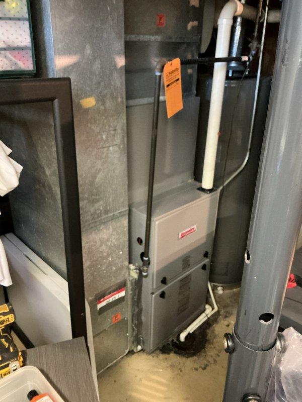 Performed routine tune-up on a 4-year-old gas furnace with no reported issues. Inspected the burner assembly, heat exchanger, draft inducer motor and blower, wiring harness connections, gas piping, and PVC exhaust and condensate drain lines, and confirmed the unit was operating properly. Noted dust and debris buildup inside the cabinet and staining on the floor beneath the unit, and recommended monitoring the condensate drain line for leaks.