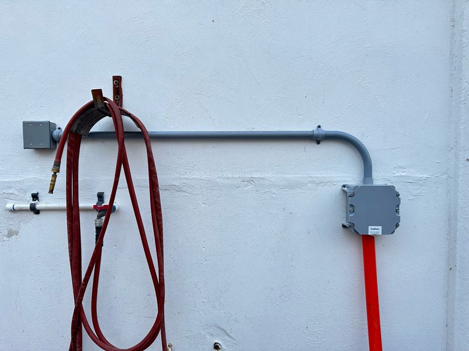 Run Wiring underground for data. This job was especially gratifying. By using directional boring, we were able to extend internet service from one building to another that is across the street. This allows the customer to streamline their monthly bill and network the entire company without incurring additional charges. Fiber Optic cable installed here.