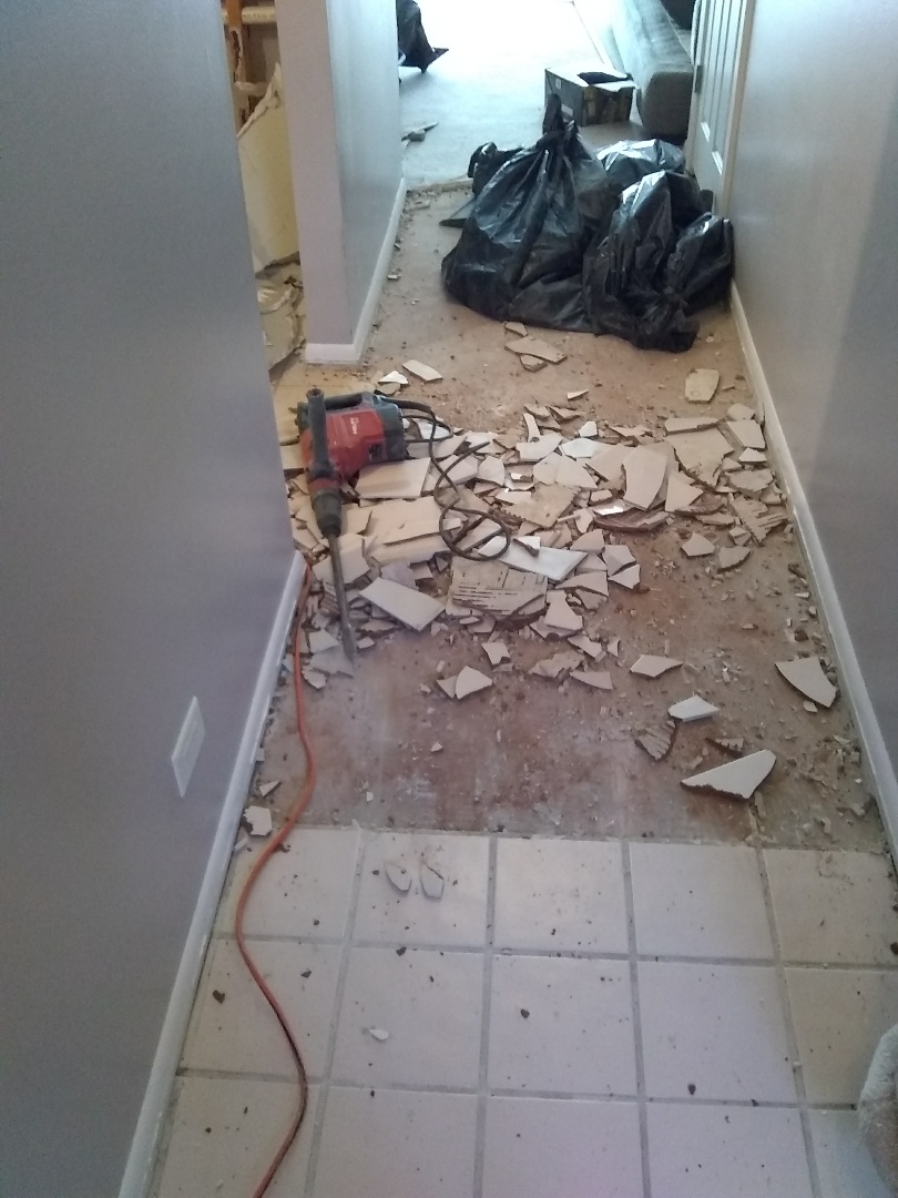 Schaumburg, IL - Removal of ceramic tile from hallway, new laminate flooring will be installed. Schaumburg, IL - Removal of ceramic tile from hallway, new laminate flooring will be installed.