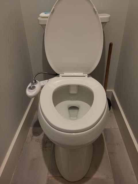 Responded to a call for a clogged toilet in the main bathroom, more than likely due to a piece of the bidet toilet seat breaking off. Once on site, found only toilet was clogged. We performed drain cleaning with a hand auger to clear the blockage. Once blockage was cleared, we installed a new bidet seat that the customer had purchase. 