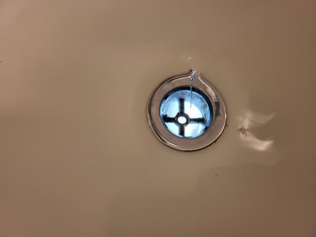 We were called out after our customer noticed water leaking through the kitchen ceiling whenever the upstairs bathtub was used. Once onsite, we ran the water in the upstairs tub to confirm if this could be causing the leak. After inspection, we confirmed water was dripping from above. We cut open the sheetrock ceiling and found that the tub shoe fitting under the upstairs tub was leaking. We removed the damaged fitting and repaired the leaking tub shoe. After the repair was complete, we ran the bathtub multiple times to test for leak free operation. 