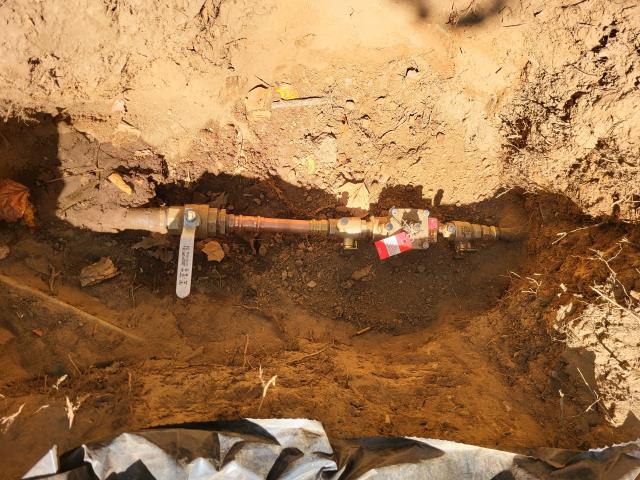 We responded to our customer due to repairs and upgrades on the irrigation system. Once onsite, we located the service line and dug down to access and replace the main shut off valve that was no longer working properly. Once the new valve was installed, we also installed a backflow prevention device. Once installation was complete, we ran a test for leak free operation. To provide long term protection and easy access, we installed two metal valve boxes around the shut off and backflow device. After everything was completed, we backfilled and buried the hole.
