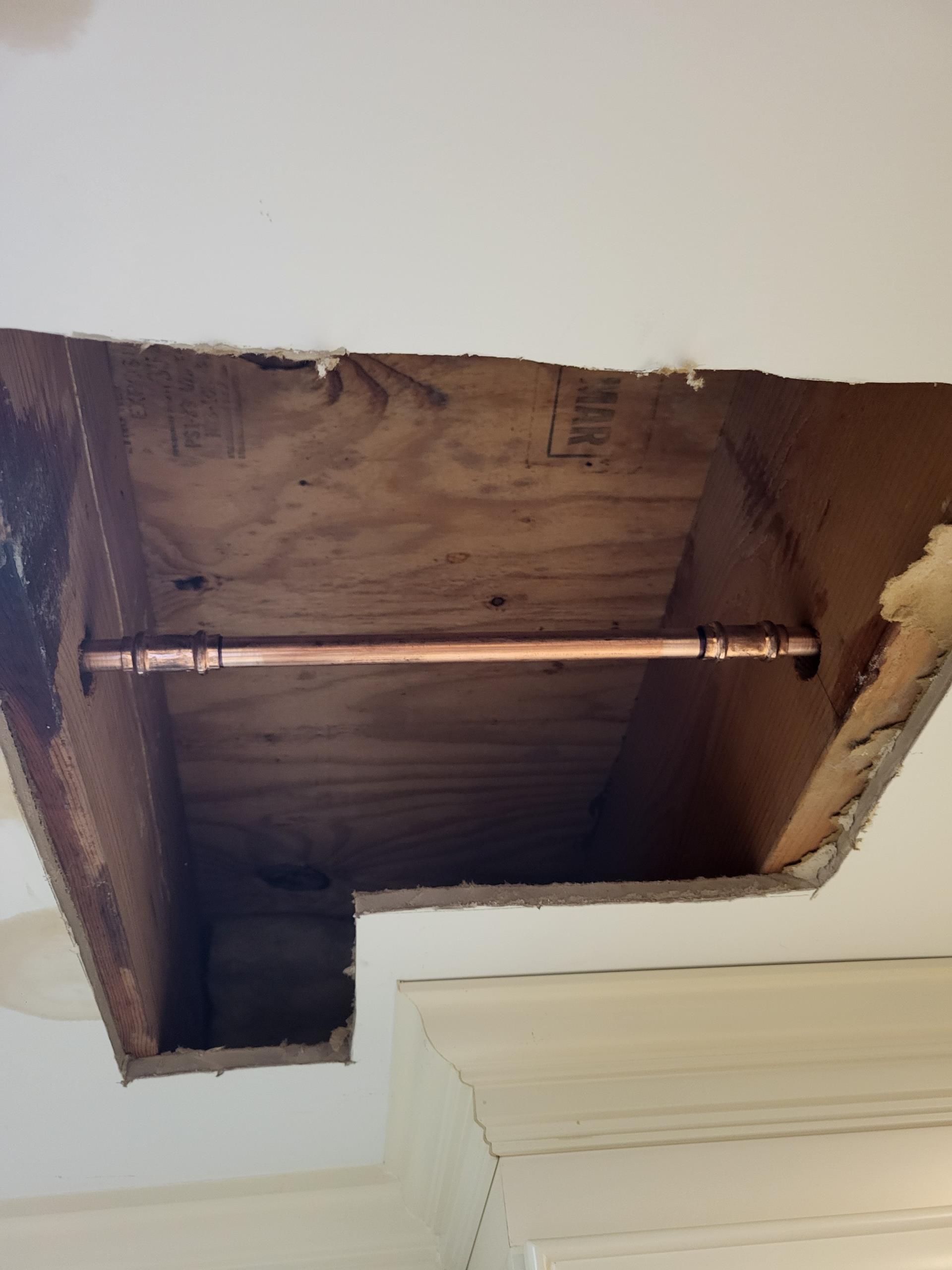 We responded to our customer after they reported signs of a water leak coming from the kitchen ceiling. After inspection, we cut and removed a small section of the sheetrock for access and discovered a pin hole leak in the copper water line above. The pipe had began to corrode, causing a small but steady drip. We cut out the damaged section of copper and installed a new copper pipe. Once the repair was completed, we turned the water back on thoroughly tested the line to confirm leak free operation.

