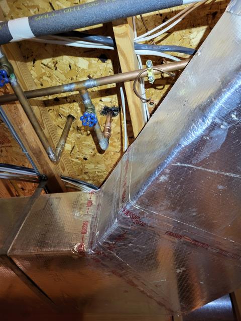 We responded to our customer due to them noticing their carpet was wet on the main floor. Once on site, we started by checking all upstairs fixtures for any visible leaks but didn't find any active sources there. We then inspected the basement ceiling and found water dripping where two pieces of plywood meet, near the wall where the water risers run between floors. To locate the problem, we cut open the sheetrock in the affected area and found a leak on the 3/4" copper water lines. We removed the damaged section of the copper pipe and installed the new 3/4" Copper pipe to make a permanent repair. Once the replacement was complete, we turned the water back on and tested for leak free operation.