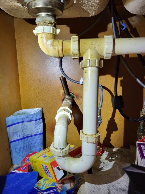 We responded to our customer due to water appearing under the kitchen sink when the faucet was running. Upon arrival, after inspecting the sink drain assembly, we found that the left basket strainer was corroded and no longer sealing properly, which was allowing water to leak into the base cabinet. We removed the damaged basket strainer and installed a new one to create a proper water tight seal at the sink basin. We also replaced the tail piece to ensure the drain piping was secure and correctly aligned. All connections were tightened and supported to prevent any future movement or shifting. Once the installation was completed, we ran water through the sink and tested the drain for any leaks. 