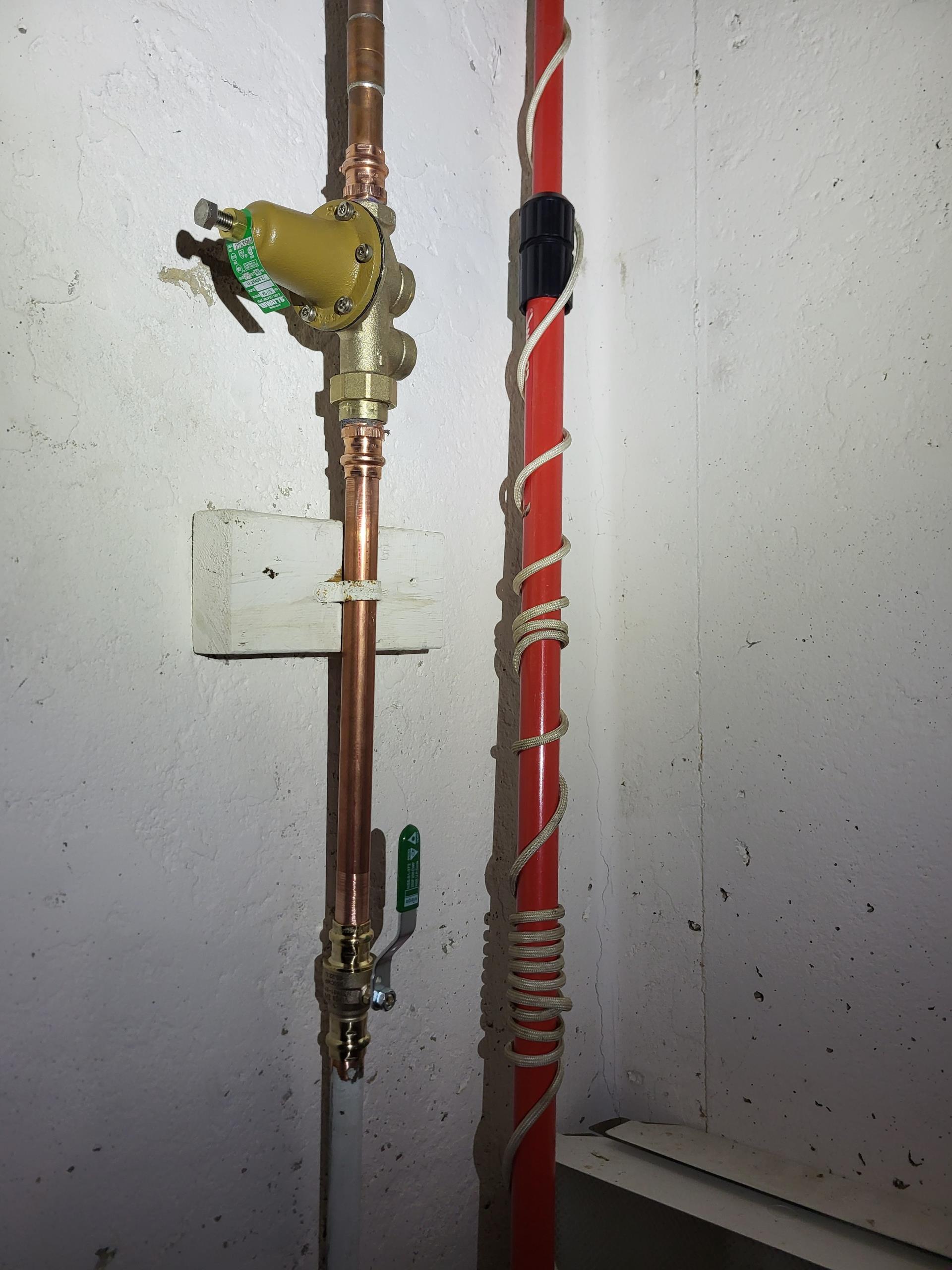 We responded to our customers home to address issues with the main water line supply and aging valves in the basement. After evaluating the plumbing system, we found that the existing pressure reducing valve (PRV) and the main shut off valve were no longer operating reliably. We removed the old components and installed a new PRV and shut off valve to restore proper water pressure control and dependable isolation of the homes water supply. We also inspected the nearby expansion tank and determined it had failed, so we replaced it with a properly sized new unit to help regulate thermal expansion within the plumbing system. In addition, we replaced a worn off shut off valve for the exterior hose bibb to ensure smooth operation and prevent future leaks. Once all installations were complete, we pressurized the system and verified leak free operation throughout the home.
