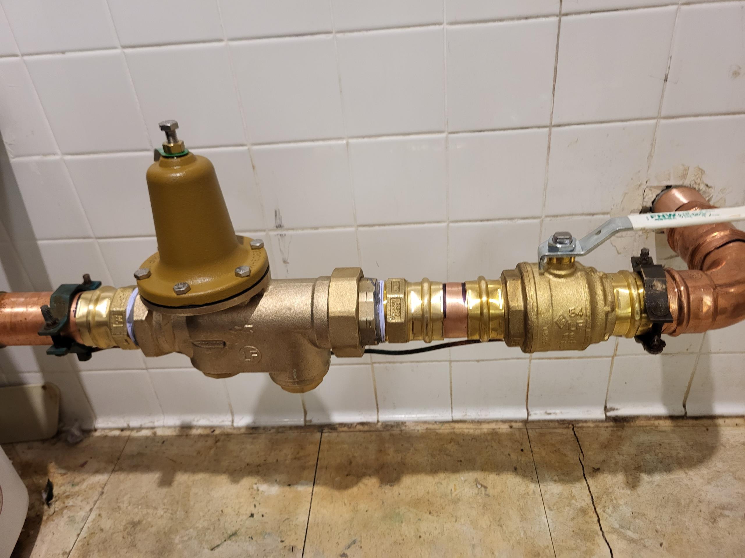 We responded to our customer due to issues with inconsistent water pressure and difficulty operating the existing main shut off valve. Once on site, after evaluation, we determined that the two inch main shut off valve and the two inch pressure reducing valve (PRV) were outdated and no longer functioning properly. To restore proper control of the homes water supply, we installed a new Watts pressure reducing valve along with a quarter turn ball valve for easier operation. All fittings and connections were secured to ensure long term reliability. Once installation was completed, we tested the system for proper, leak free operation and set the water pressure system to the correct level.  