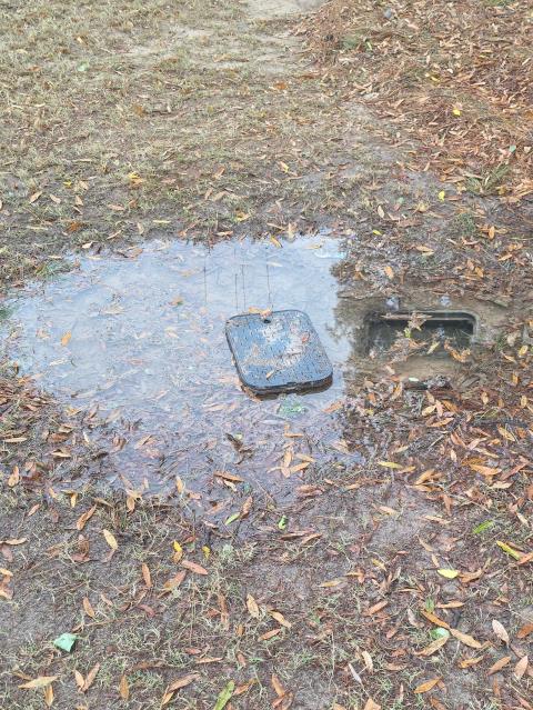 We responded to our customer due to water pooling near the playground area, indicating a possible underground leak. Upon arrival, to locate the source, we moved back the turf and dug down to expose the plumbing beneath. Once the area was opened, we discovered that the irrigation system was leaking from a damaged black rubber supply tube. Since irrigation systems require specialized components and adjustments, we recommended an irrigation company complete the repair to ensure long term reliability. To stop the active leak and prevent further water loss or ground saturation, we turned off the irrigation system. After securing the area, we backfilled the hole and restored the turf to its original position. Also during our visit, we found the meter box completely full of water. We pumped out the standing water and turned the water back on to locate the source of the leak. After testing, we determined there was an active water leak on the copper line just after the water meter.  