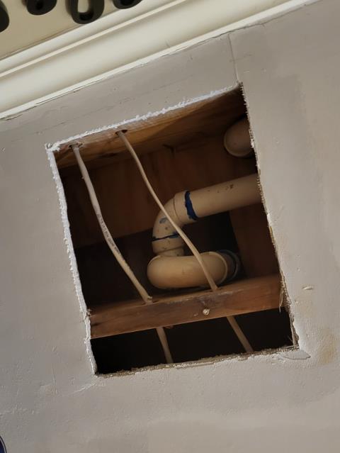 We responded to our customer after they noticed water leaking onto the main floor when the upstairs bathtub was being used. Once on site, we tested the tub and drain system and did not find any active leaks coming from the tub shoe, overflow, or plumbing connections. To further investigate this issue, we ran the tub and splashed water around the tub spout and trim area. During testing, we observed water getting behind the trim, which was allowing moisture to travel into the wall and leak down to the level below. This type of leak is often caused by failed or missing sealant around the tub trim. To resolve this issue, we sealed the trim with clear caulking to create a water tight barrier. After sealing, we retested the area to confirm water was no longer getting behind the trim. 