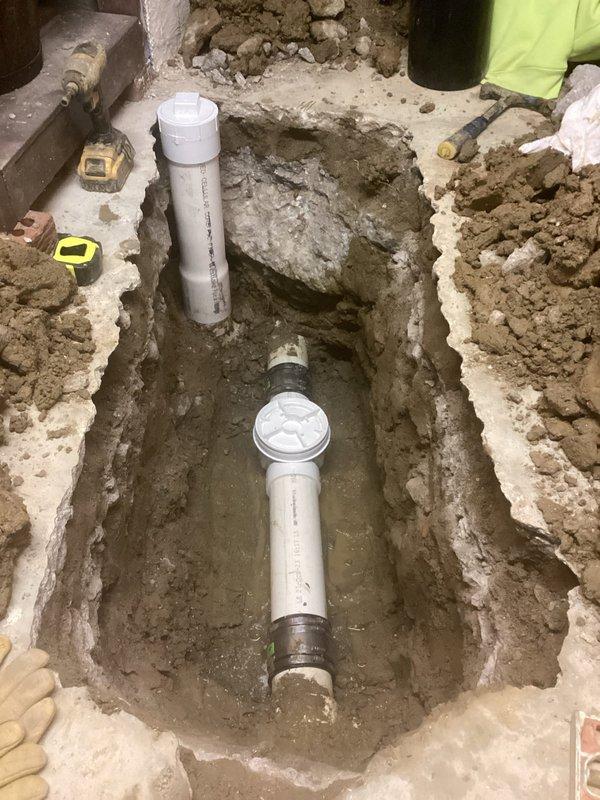 Excavated concrete floor and installed new 4" PVC backwater valve with riser kit and lid to prevent sewer backups. Simultaneously installed new 4" PVC cleanout for improved system access and maintenance. Completed job with proper concrete restoration and removal of all debris from premises.