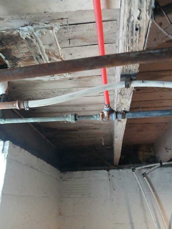 Completed pipe connection repair for client Robert Hill on a time and materials basis. Opened wall sections to access and connect plumbing pipes, installing new PEX piping and connecting to existing metal fittings. Work involved integrating new components with older plumbing infrastructure in basement/crawlspace area as pre-approved by Tessa.