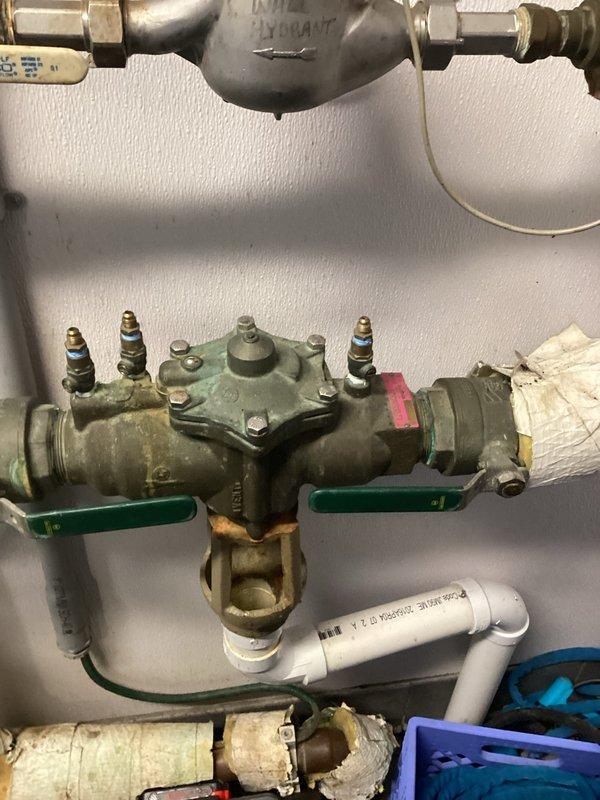 Performed scheduled backflow testing on device with work order #944710. Inspected aging backflow preventer showing signs of oxidation and deteriorated insulation. Test completed successfully; device is functioning properly but recommended monitoring the deteriorating components for potential future replacement.