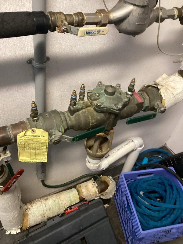 Performed scheduled backflow testing on device with work order #944710. Inspected aging backflow preventer showing signs of oxidation and deteriorated insulation. Test completed successfully; device is functioning properly but recommended monitoring the deteriorating components for potential future replacement.