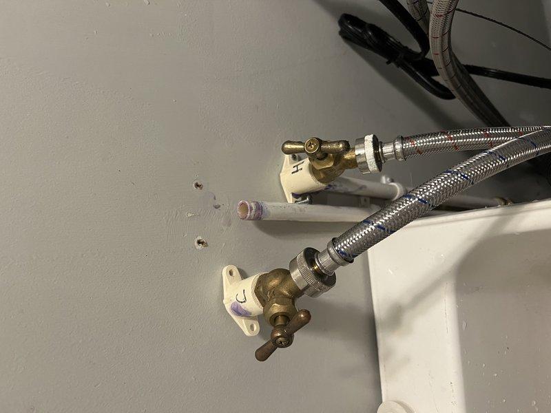 Inspected and repaired a leaking water valve in the laundry room. Identified the source of the leak at the brass valve connection point where the stainless steel braided supply line connects. Replaced the faulty valve and verified proper operation with no further leakage.