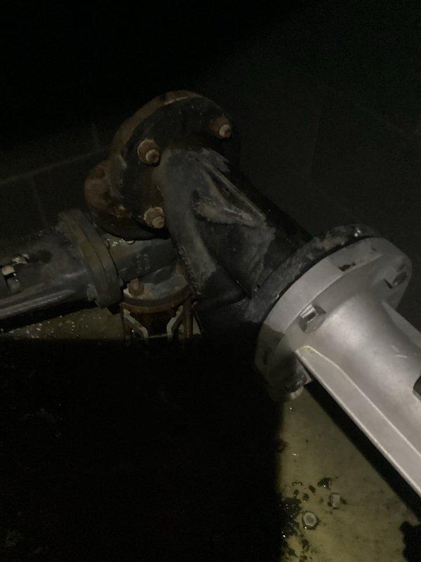 Responded to service call for main water line leak occurring inside property before the meter. Upon inspection, discovered severely corroded metal pipe connection with visible water pooling around the mechanical joint. Replaced deteriorated pipe section and flanged connection, securing with new bolts to ensure watertight seal. Confirmed proper operation with customer before departure.