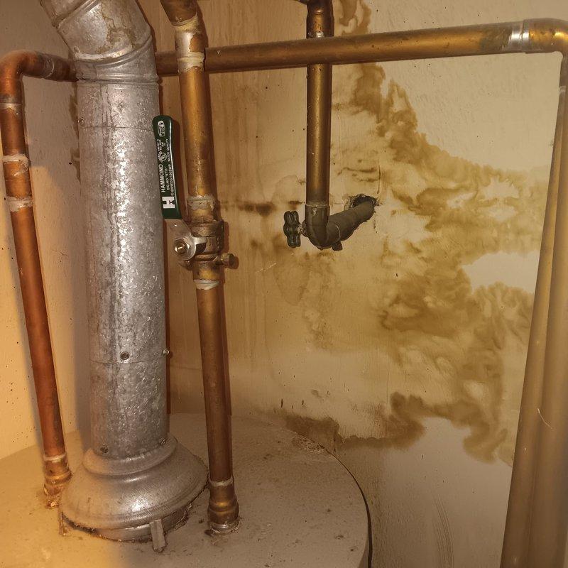Inspected main water valve at condo unit and identified significant water damage on wall adjacent to water heater, likely from valve leakage. Repaired defective main valve to restore proper functionality and examined bathroom tub diverter/spout, completing necessary repairs to resolve water flow issues.