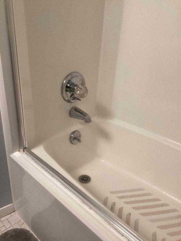 Repaired leaking shower diverter valve in guest bathroom and properly secured loose toilet to floor. Corrected improperly installed kitchen trap and tightened exterior hose attachment to resolve multiple plumbing issues throughout the residence.