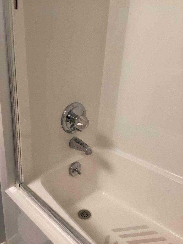 Repaired leaking shower diverter valve in guest bathroom and properly secured loose toilet to floor. Corrected improperly installed kitchen trap and tightened exterior hose attachment to resolve multiple plumbing issues throughout the residence.