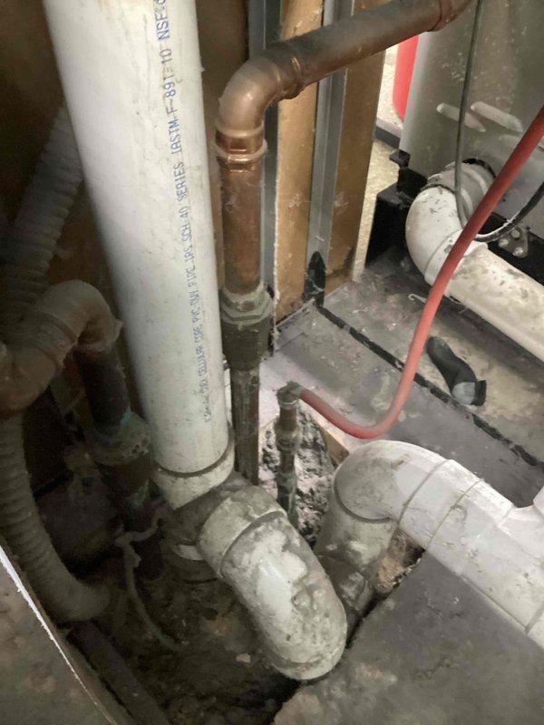 Conducted site assessment for installation of a cleanout on sewer line system. Inspected existing PVC drainage infrastructure including P-trap configuration and surrounding plumbing components. Evaluated access points and mechanical connections to determine optimal location for cleanout installation that would provide effective maintenance access while maintaining system integrity.