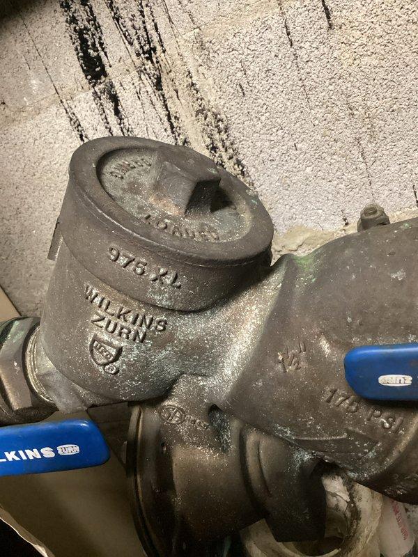 Responded to commercial water leak at Brueggers Bagels. Identified leaking pipe in office closet, which required service to a Wilkins Zurn 975-XL valve with visible corrosion and aging components. Repaired and tested the plumbing system to ensure proper operation and no further leakage.