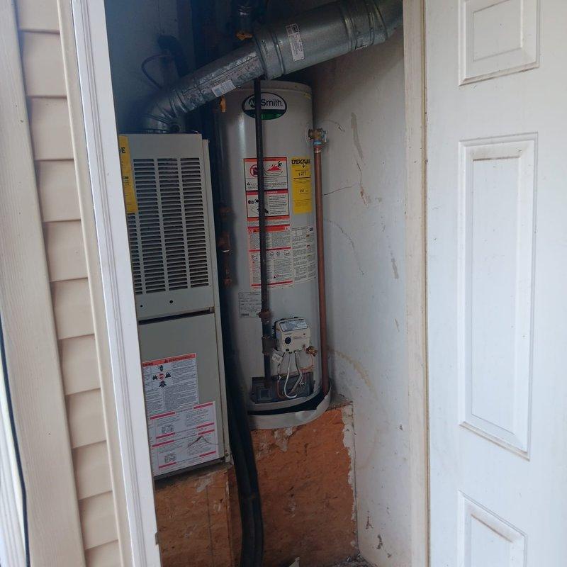 Replaced failed water heater with new A.O. Smith unit per tenant's authorization. Installed new copper piping with appropriate valves and fittings, ensuring proper venting through existing flue. All connections were soldered and tested for leaks before restoring service.
