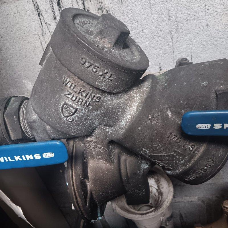 Responded to service call for water leak in closet. Inspected and serviced Wilkins Zurn valve assembly showing signs of leakage. Repaired pressure-rated fitting connected to PVC piping, eliminating the leak and restoring proper system function.