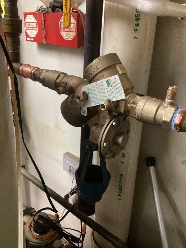 Removed and disposed of old backflow device and installed new 1 1/2" Wilkins 975 XL backflow preventer in mechanical room. Performed required testing of the newly installed device to confirm proper operation and compliance with regulations.