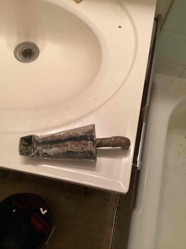 Responded to a callback regarding persistent faucet leakage around drain area. Upon inspection, discovered heavy corrosion and mineral buildup on the faucet components. Removed and replaced the affected hardware to resolve the ongoing leak issue.