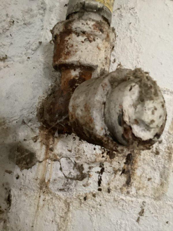 Inspected and replaced non-functioning sump pump in basement. Noted significant corrosion on existing water heater connections and T-junction pipe fitting with extensive rust formation and mineral deposits. Observed multiple plumbing leaks requiring attention including kitchen sink drain, bathroom sink drain, and bathroom faucet, but focused on sump pump replacement as primary service.