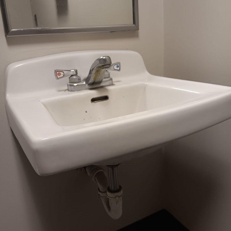 Provided pricing quote for the replacement of one toilet and one wall-mounted sink in a single restroom due to a minor leak at the toilet base. Quote included itemized breakdown of materials, labor, and tax as requested, with photo documentation of existing fixtures and bathroom conditions for accurate assessment.