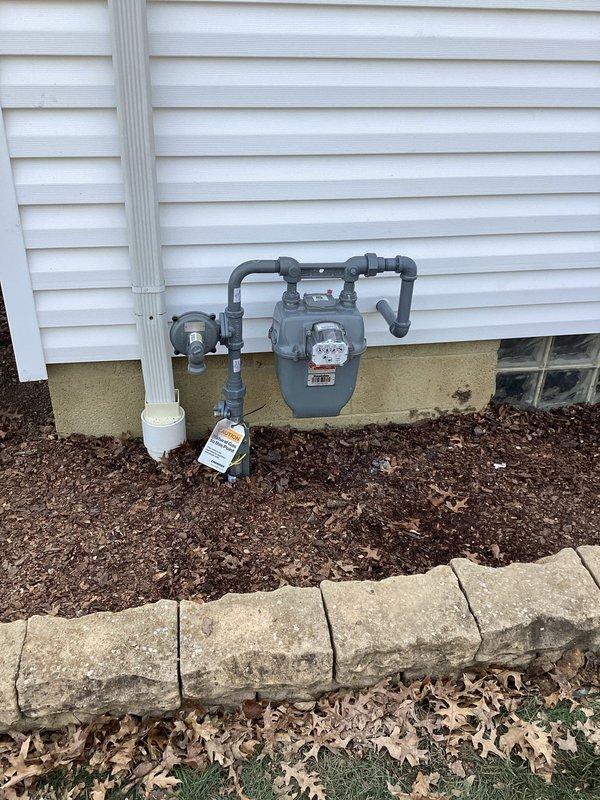 Completed gas line valve installation per option B specifications with 50% deposit collected. Accessed crawl space and basement area to route new gas piping through existing floor joist system alongside ductwork and insulation. Installed gas meter assembly on exterior wall with appropriate shutoff valves and connections. Per customer request, existing gas line for dryer was left in place and not removed from the system. Documentation photos captured of crawl space routing and exterior meter installation with all connections properly secured and tested.