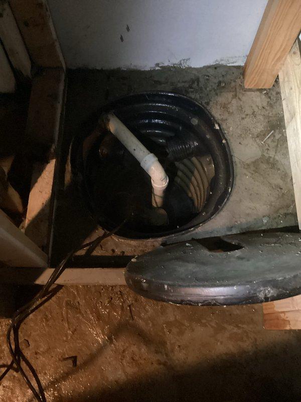 Responded to water intrusion and low water pressure concerns in basement following recent municipal water work. Conducted thorough inspection of interior plumbing systems to determine if issues originated from property systems or external municipal infrastructure. Examined sump pump installation, basement plumbing connections, and drainage systems. Documented conditions showing water penetration through foundation wall and assessed PVC piping, trap assemblies, and connection points for leaks or damage. Inspection revealed no interior plumbing failures or defects that would account for reported symptoms. Findings confirmed water intrusion and pressure issues consistent with external source related to recent city water line work, eliminating interior plumbing as contributing factor.