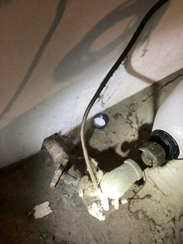 Responded to water intrusion and low water pressure concerns in basement following recent municipal water work. Conducted thorough inspection of interior plumbing systems to determine if issues originated from property systems or external municipal infrastructure. Examined sump pump installation, basement plumbing connections, and drainage systems. Documented conditions showing water penetration through foundation wall and assessed PVC piping, trap assemblies, and connection points for leaks or damage. Inspection revealed no interior plumbing failures or defects that would account for reported symptoms. Findings confirmed water intrusion and pressure issues consistent with external source related to recent city water line work, eliminating interior plumbing as contributing factor.