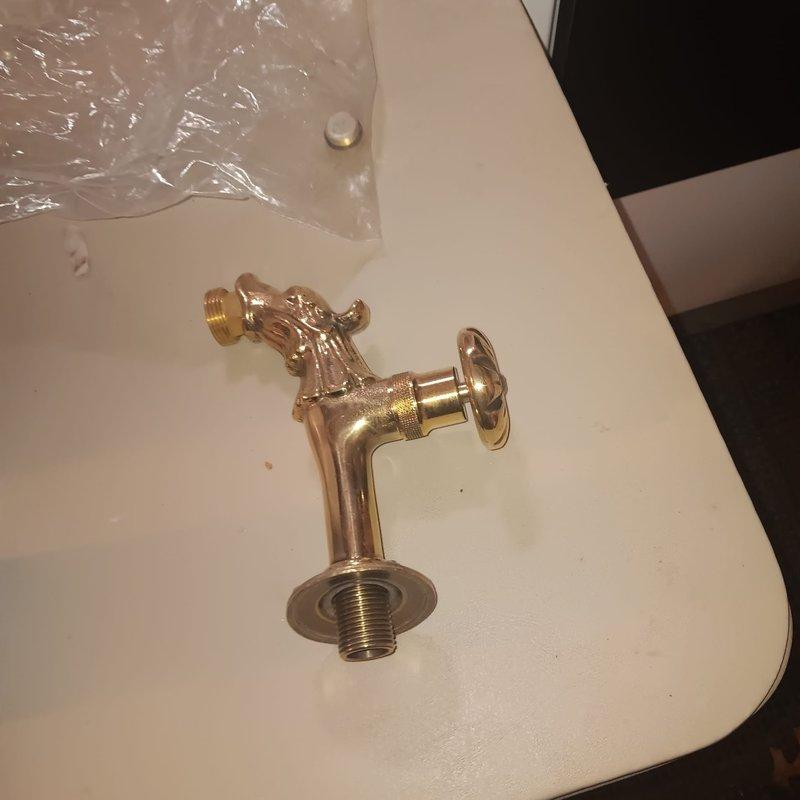 Responded to a service call for a drain issue and outdoor faucet installation at a century-old residential property. Removed the existing exterior hose bib that showed significant rust staining and mineral deposits on the foundation, indicating long-term leakage or drainage problems. Installed a new decorative brass outdoor faucet with proper mounting and threaded connections to the foundation wall, ensuring secure attachment and proper sealing to prevent future water intrusion. Verified water flow and tested for leaks upon completion.