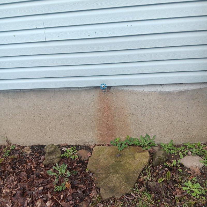 Responded to a service call for a drain issue and outdoor faucet installation at a century-old residential property. Removed the existing exterior hose bib that showed significant rust staining and mineral deposits on the foundation, indicating long-term leakage or drainage problems. Installed a new decorative brass outdoor faucet with proper mounting and threaded connections to the foundation wall, ensuring secure attachment and proper sealing to prevent future water intrusion. Verified water flow and tested for leaks upon completion.