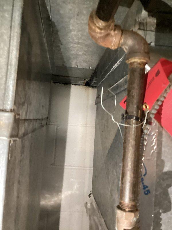 Responded to a service call for a broken and leaking pipe located near the water heater in the basement. Upon inspection, identified deteriorated copper piping showing significant age-related oxidation and corrosion, with active water leakage at the connection point. Repaired the compromised pipe section, restored proper water flow, and verified the integrity of surrounding plumbing connections to prevent future leaks.