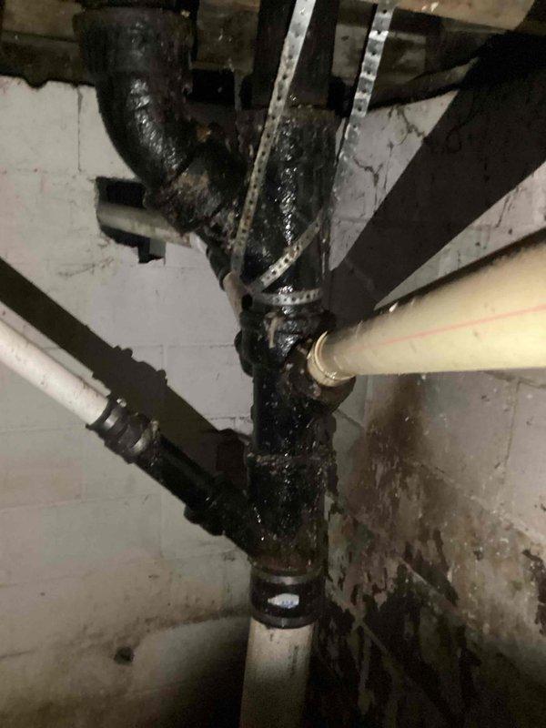 Completed comprehensive plumbing inspection focusing on second floor bathroom drainage system. Inspection revealed deteriorated bathroom stack requiring replacement, with visible corrosion and heavy buildup on existing cast iron piping at junction points. Documented conditions of drain stack connections, supporting infrastructure, and surrounding areas showing moisture damage and age-related deterioration that necessitate full stack replacement to restore proper drainage function and prevent future leaks.