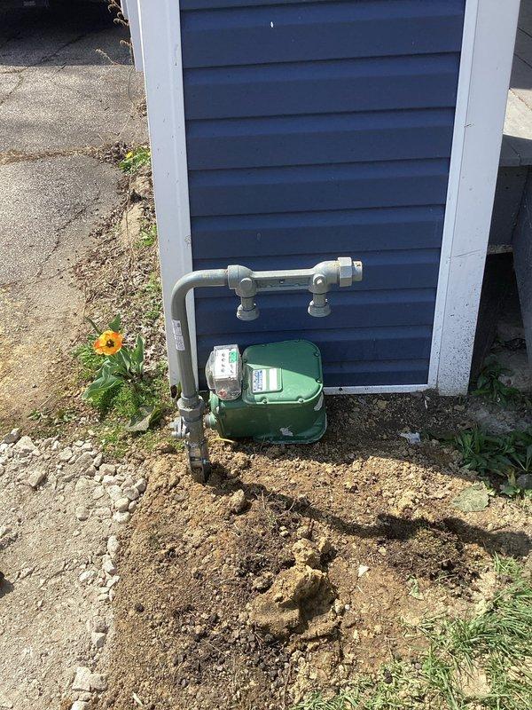Relocated commercial gas meter assembly from existing position to new exterior wall location, requiring installation of approximately 30 feet of gas piping. Installed new gas line routing from basement mechanical space through wall penetration to exterior meter location, utilizing proper supports and fittings throughout the run. Mounted green metal meter enclosure on building exterior with appropriate standoff clearances, connected supply piping with code-compliant joints and valves, and completed pressure testing to verify system integrity.