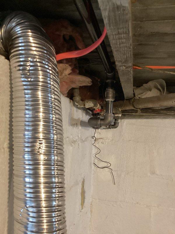 Relocated commercial gas meter assembly from existing position to new exterior wall location, requiring installation of approximately 30 feet of gas piping. Installed new gas line routing from basement mechanical space through wall penetration to exterior meter location, utilizing proper supports and fittings throughout the run. Mounted green metal meter enclosure on building exterior with appropriate standoff clearances, connected supply piping with code-compliant joints and valves, and completed pressure testing to verify system integrity.