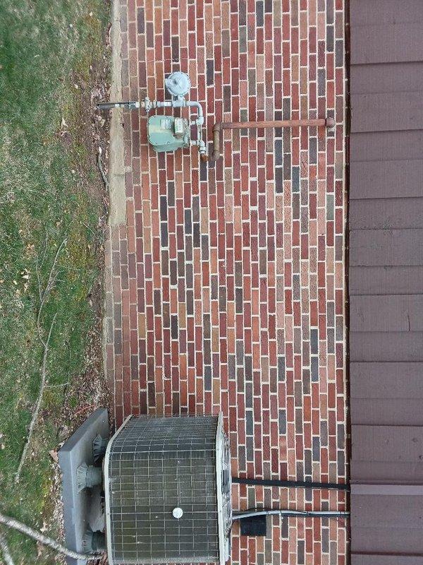 Installed approximately 10 feet of gas piping to exterior location, routing line to HVAC equipment area on brick patio. Installation completed with proper fittings and connections to supply gas service to outdoor mechanical equipment, ensuring compliance with code requirements for exposed exterior gas line applications.