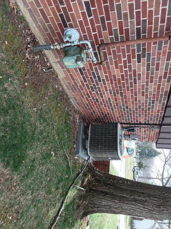 Installed approximately 10 feet of gas piping to exterior location, routing line to HVAC equipment area on brick patio. Installation completed with proper fittings and connections to supply gas service to outdoor mechanical equipment, ensuring compliance with code requirements for exposed exterior gas line applications.