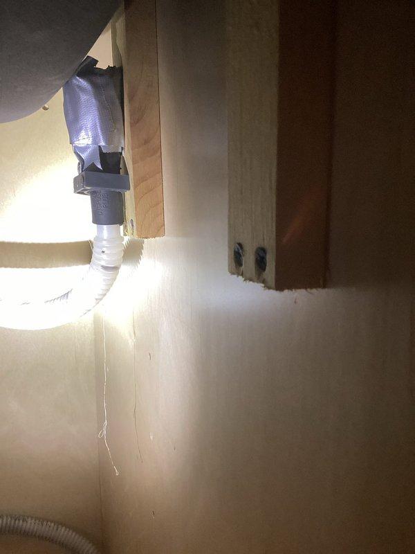 Responded to kitchen sink backup causing water to flow into dishwasher and create leak conditions. Upon arrival, accessed under-sink plumbing in cabinet area of 1951-era home. Inspected drain lines, P-trap assembly, and dishwasher drain connection for blockages and improper drainage. Cleared obstruction from drain system and verified proper water flow from sink. Tested dishwasher drain hose connection and confirmed no further backup occurring. System restored to normal operation with proper drainage established.