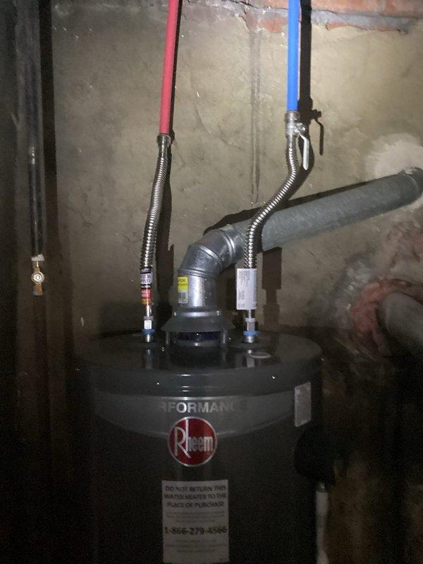 Conducted on-site assessment for whole home re-plumb estimate. Inspected existing plumbing infrastructure including water heater installation with flexible supply connectors, shut-off valves, and venting system in basement utility area. Evaluated copper supply lines and existing piping configuration throughout accessible areas to determine scope of complete residential re-piping project.